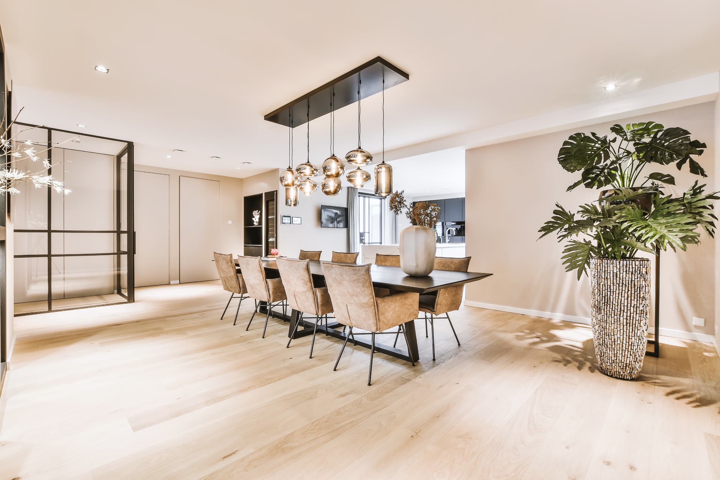 Dining room with smoked-glass pendant lights and oak floors
